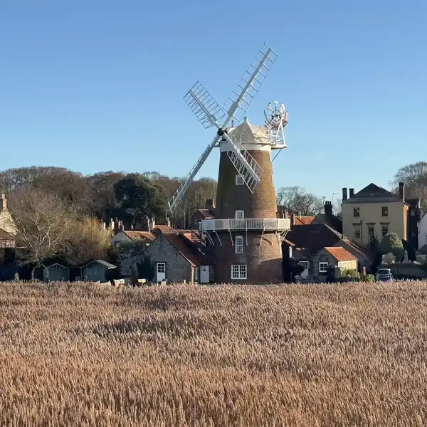 Cley Windmill overlooking reedbeds and cottages at Cley-next-the-Sea on the Norfolk Coast.