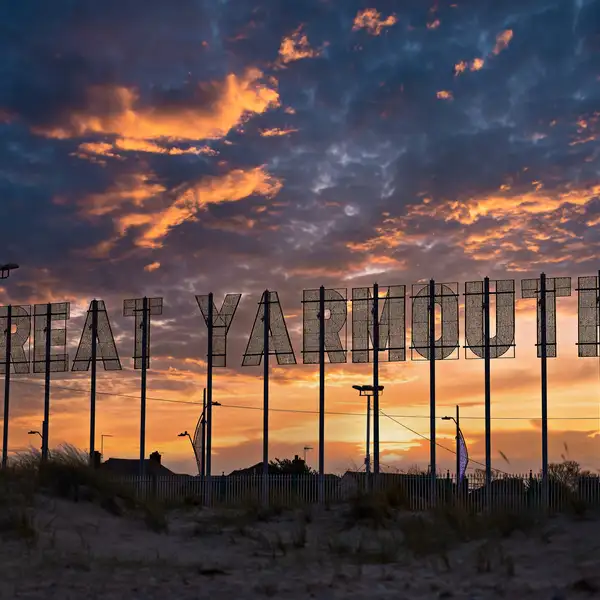 The Great Yarmouth sign at sunset on the Norfolk coast, close to onward rail and bus connections after completing the Norfolk Coast Path.