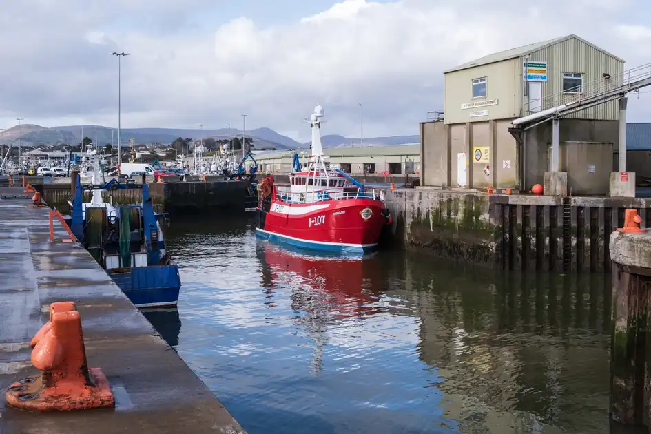 Fishing boats in Kilkeel Harbour, County Down, with the Mourne Mountains beyond