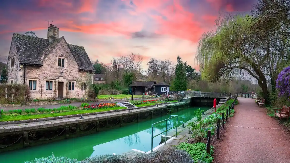 Canal lock and stone cottage beside the Thames Path in South East England.