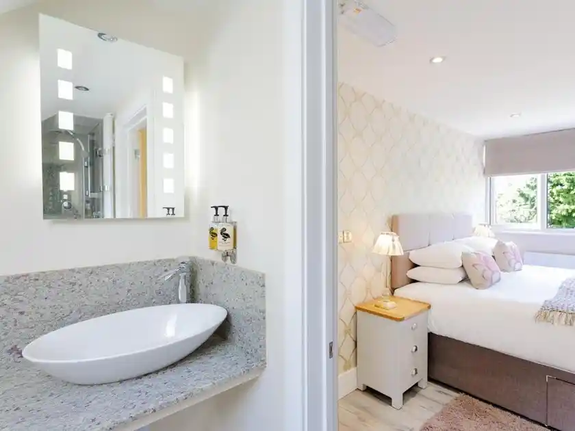 Guest bedroom with adjoining en-suite bathroom at The Orange Tree in Thornham, Norfolk.