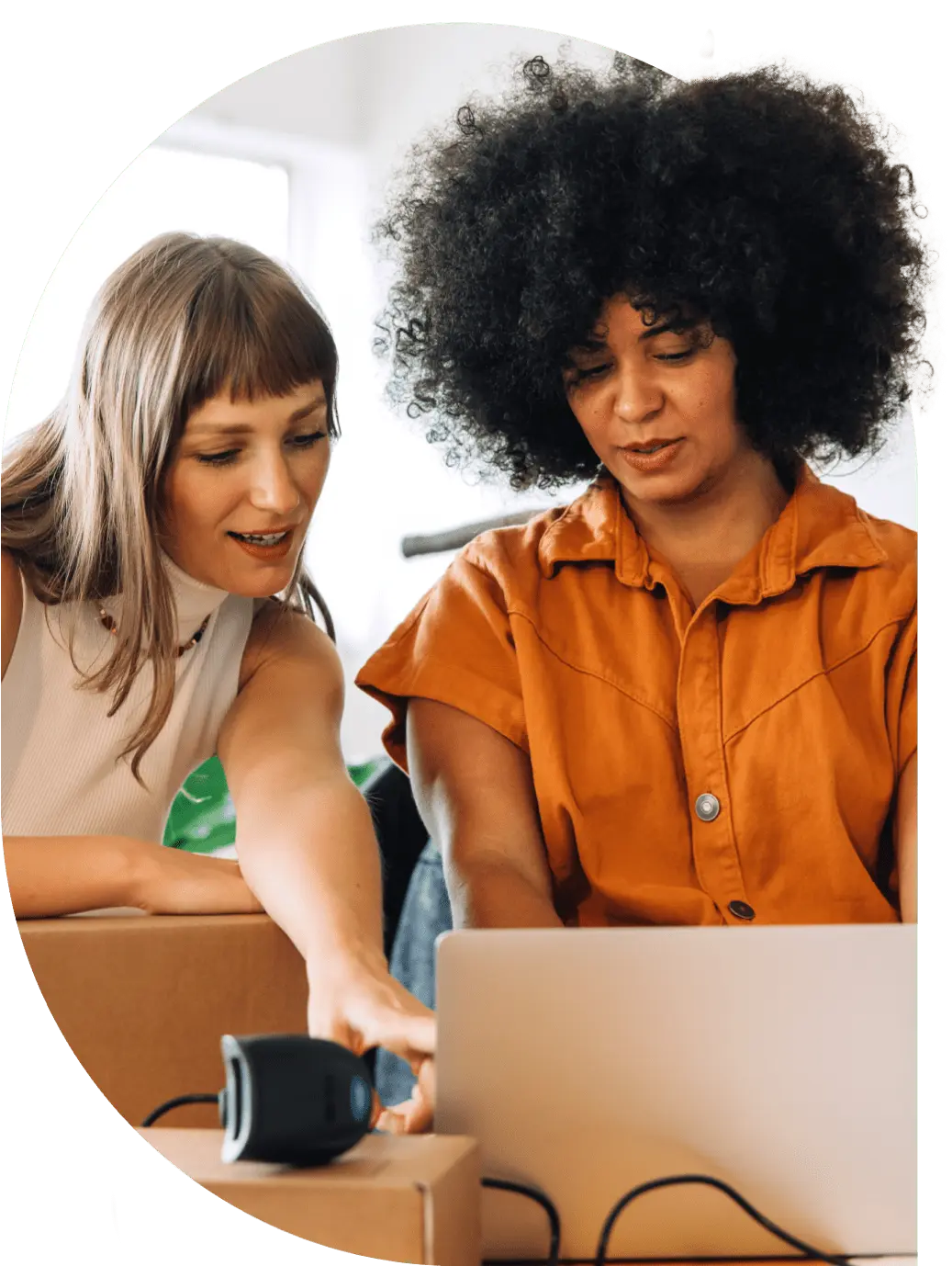 Two women working together on a laptop.