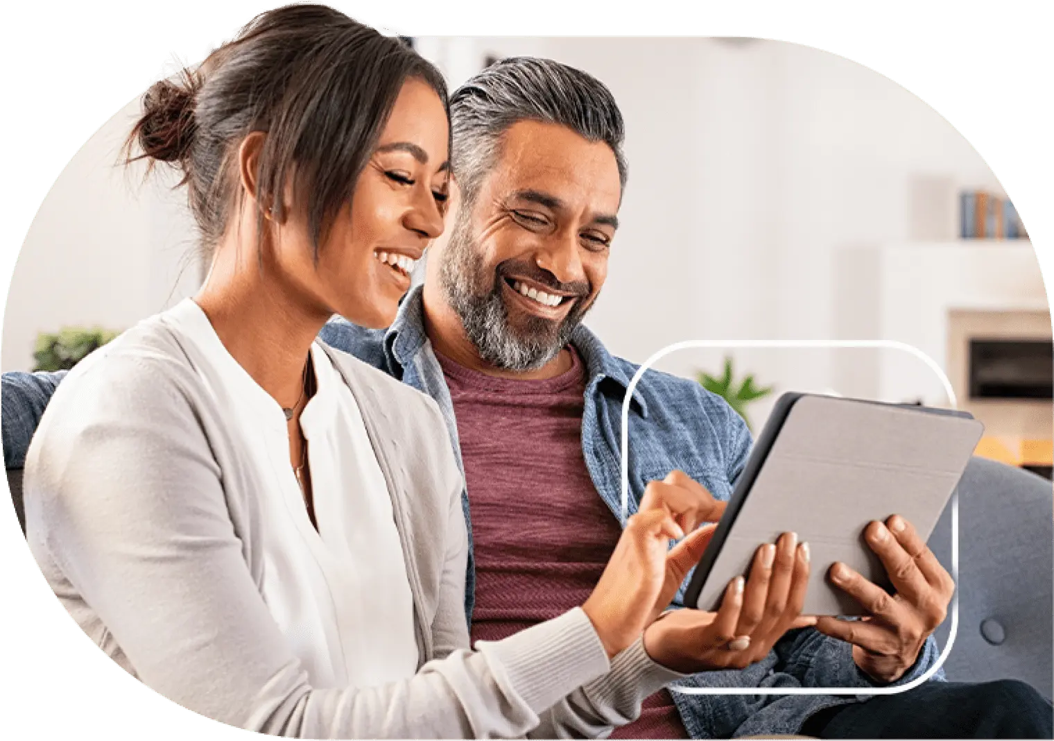 A happy couple using a tablet to shop online.
