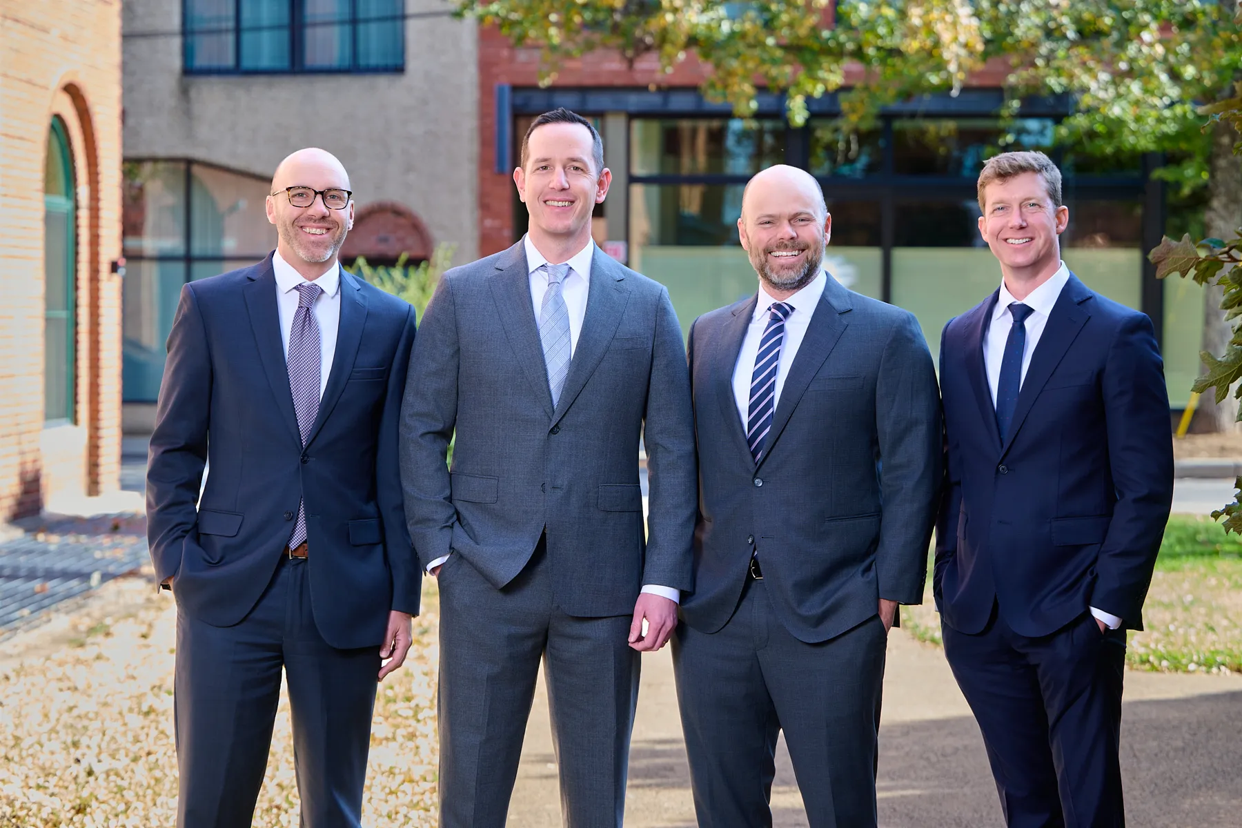 Four attorneys from Coffield Heedy Kilgore PLLC standing outdoors