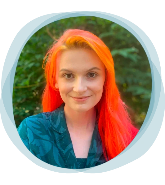 Headshot of Skye Gailing with a pale blue watercolor outline. She’s outdoors; a slight smile; and her hair is bright yellow, orange, and red.