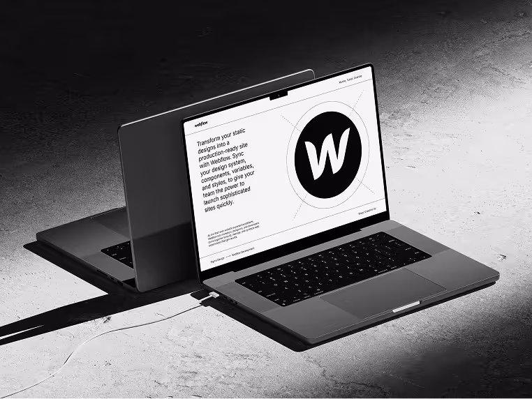 A black and white image of a laptop on a ground