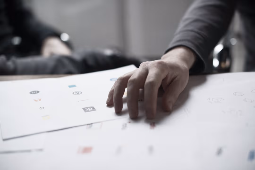 An image of person designing a logo drafts
