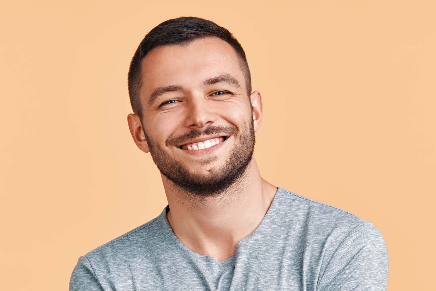 A man with a beard smiling at the camera.