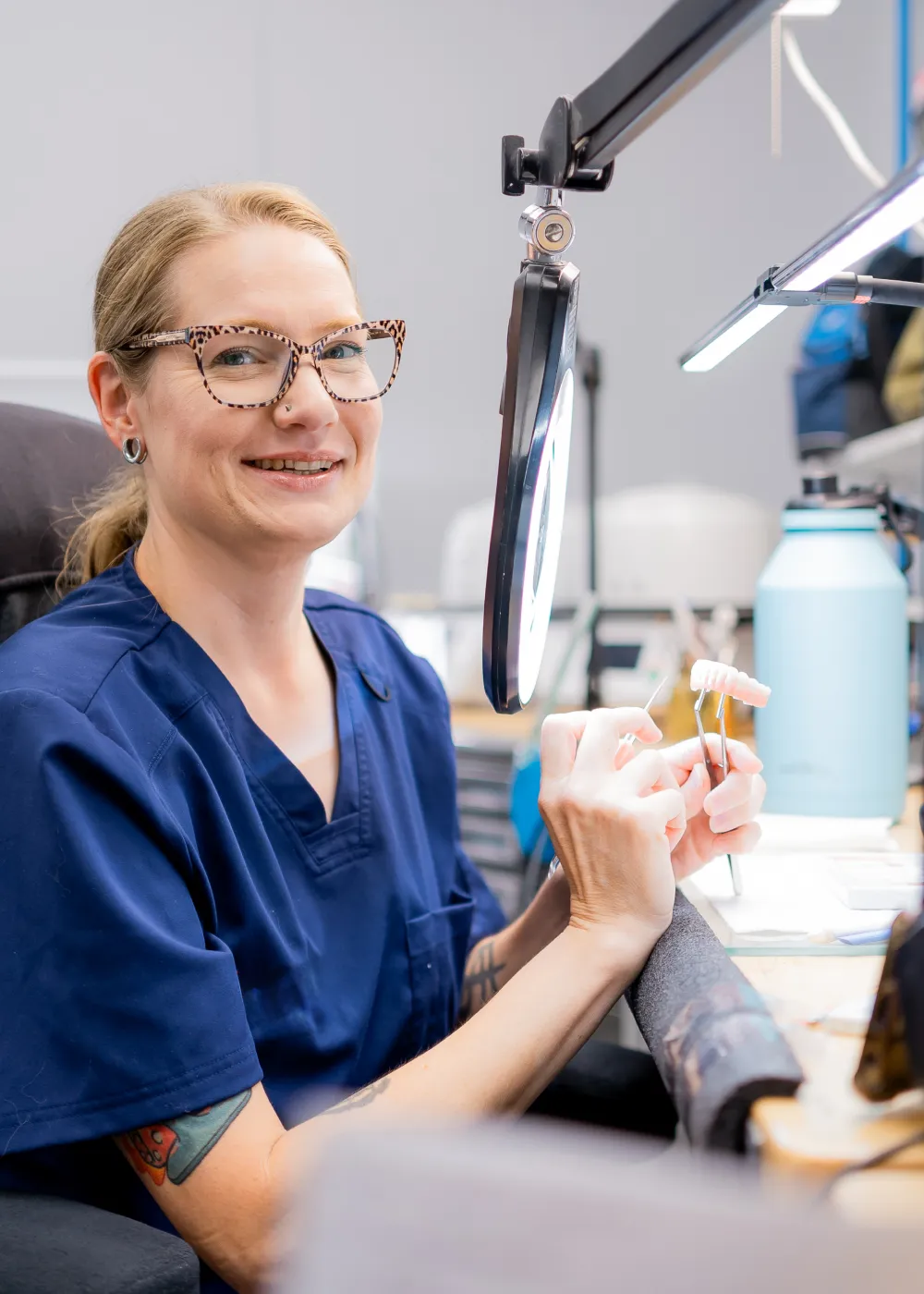 Technician holding a denture