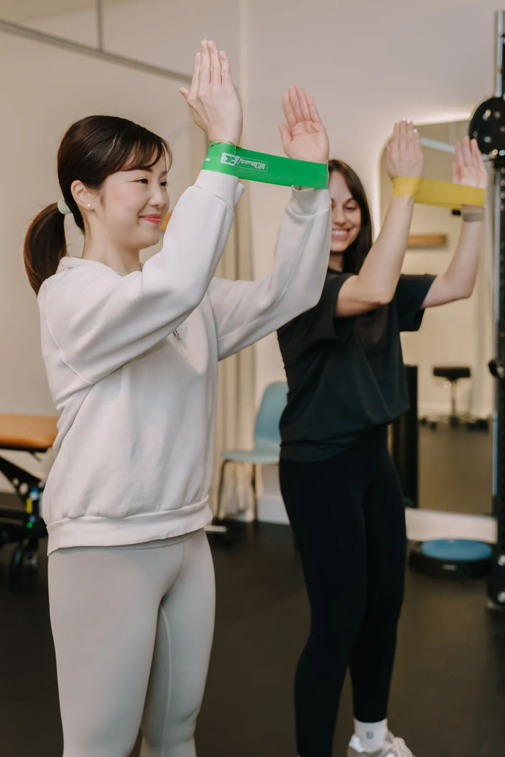 Expert Physiotherapist showing patient shoulder exercise