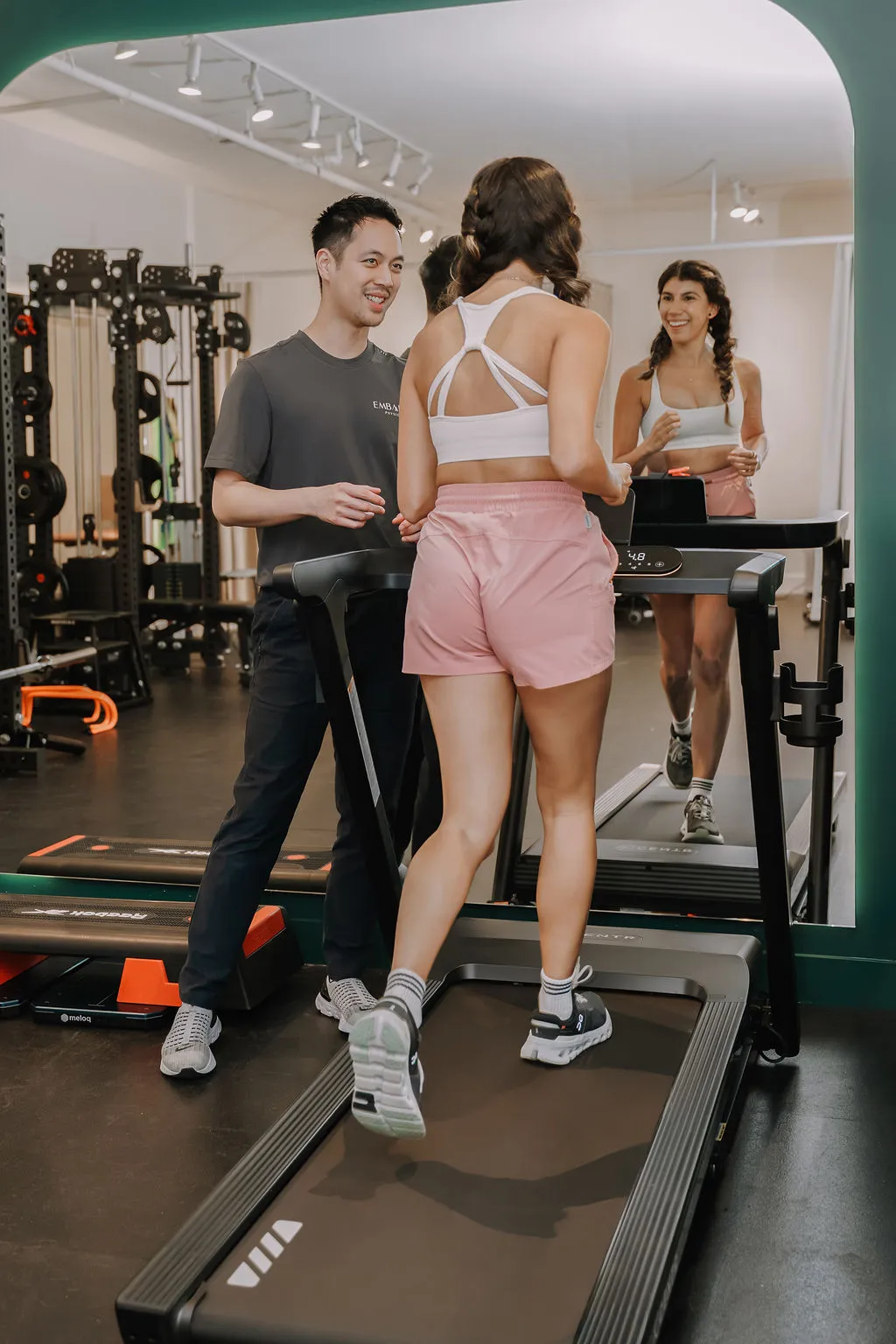 Running specialist physiotherapist doing a treadmill assessment with a patient 