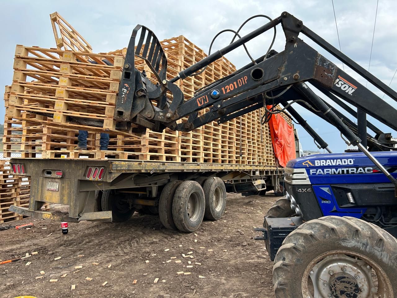 Pallets being moved by machinery