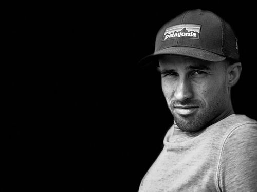 Black and white portrait of Evan Sutter, Co-Founder of SwiftReporter, wearing a Patagonia baseball cap