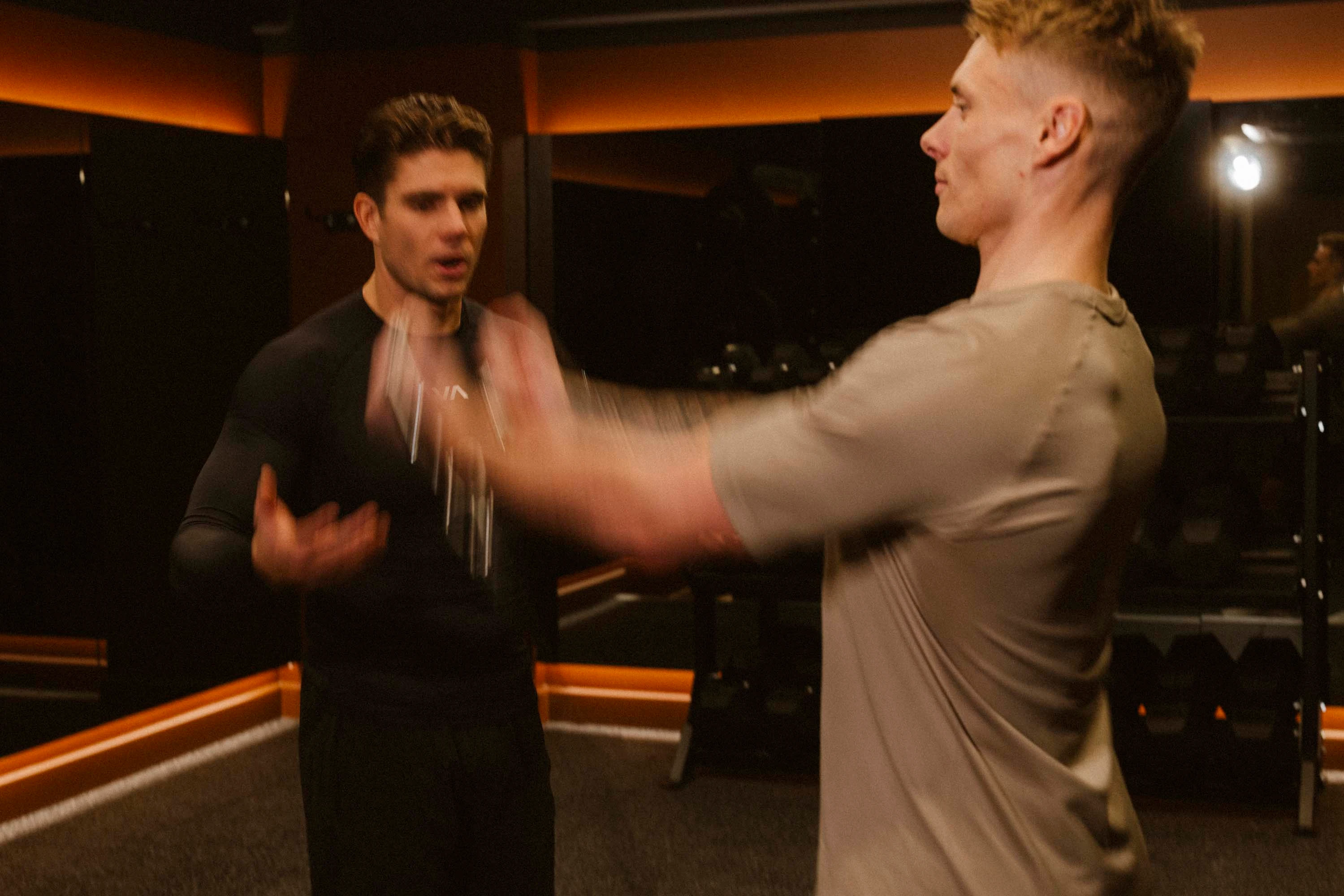 A personal trainer coaching a client in a private SOLO60 gym