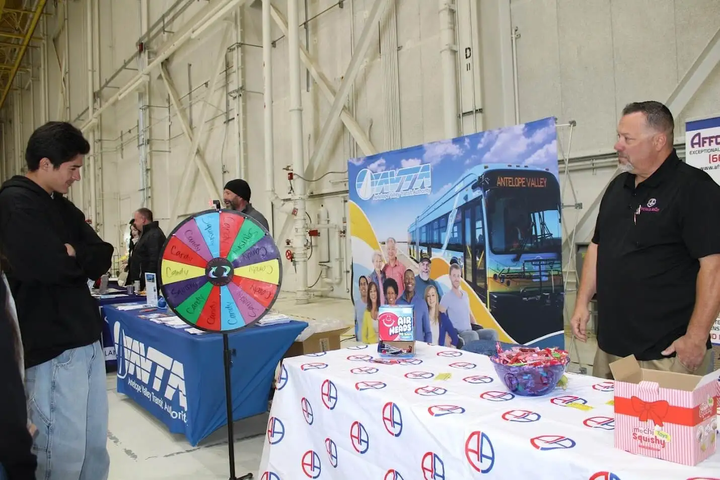AVTA booth with prize wheel and promotional materials at transportation event