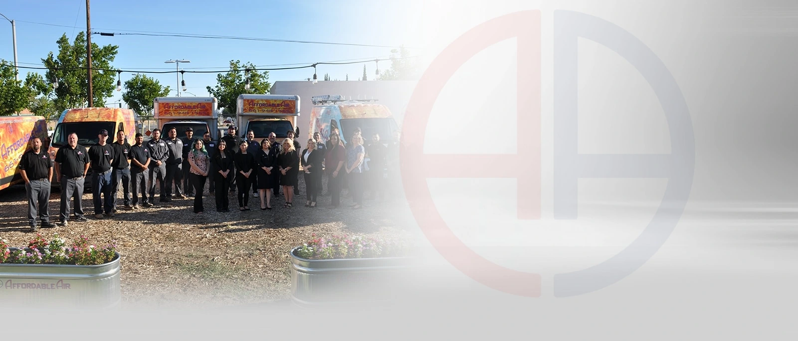 Affordable Air team posing in front of company trucks and flowering planters