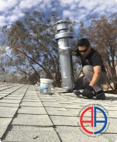 Worker installing pipe on patterned concrete with trees in background