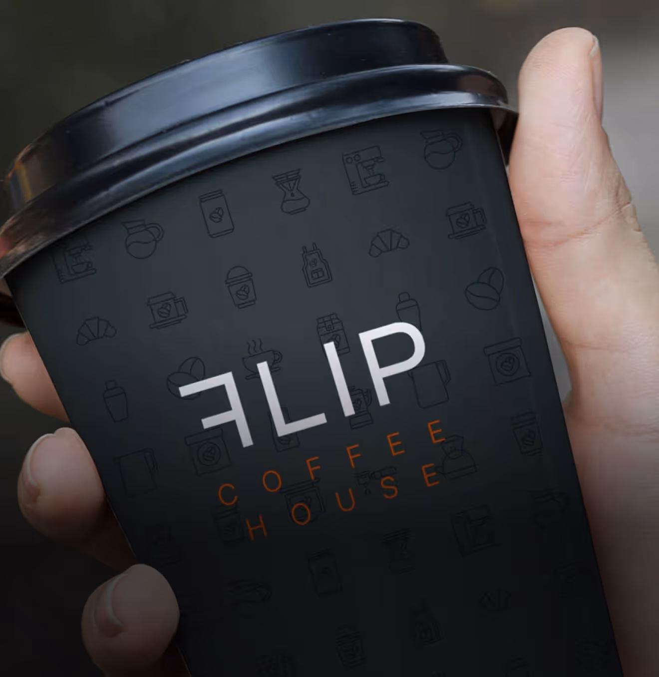 Hand holding FLIP branded coffee cup