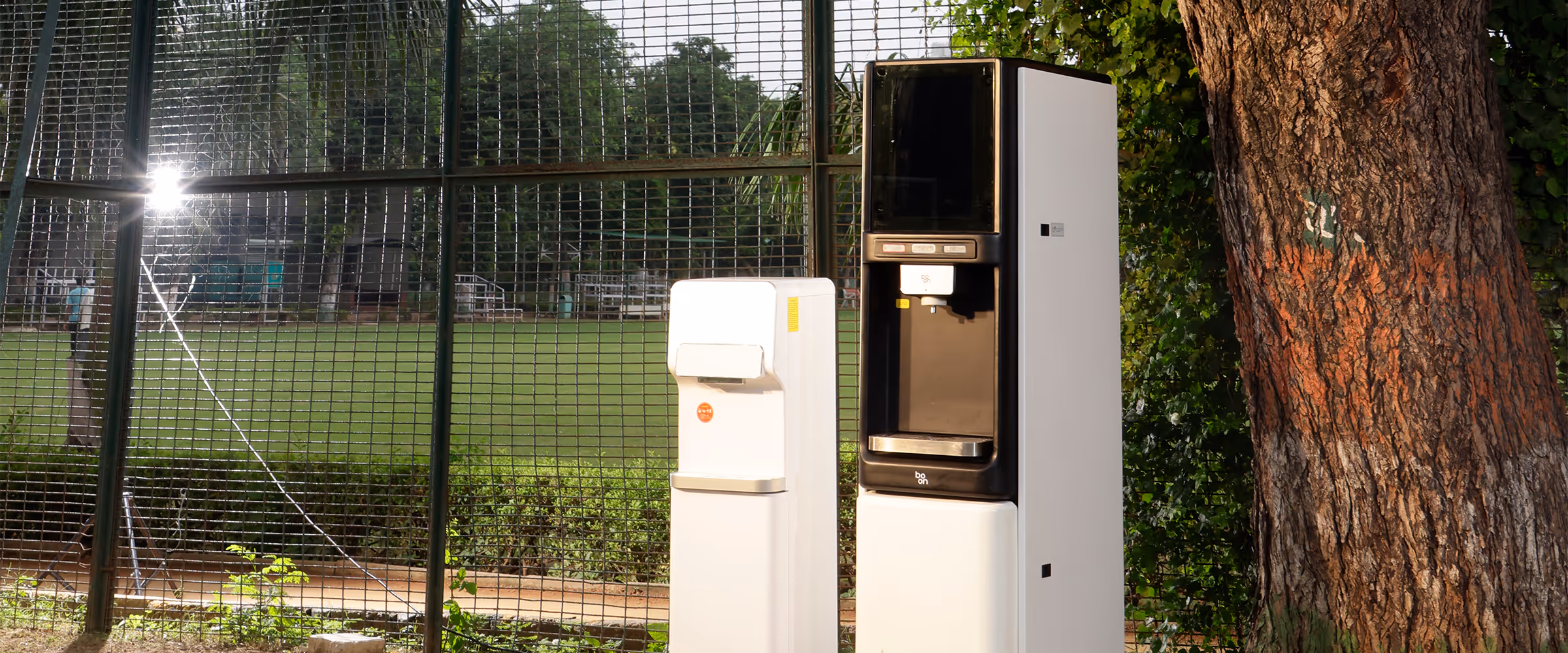 Two boon purifiers beside a tree