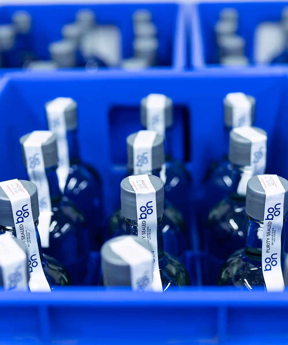 Boon water bottles in blue crates
