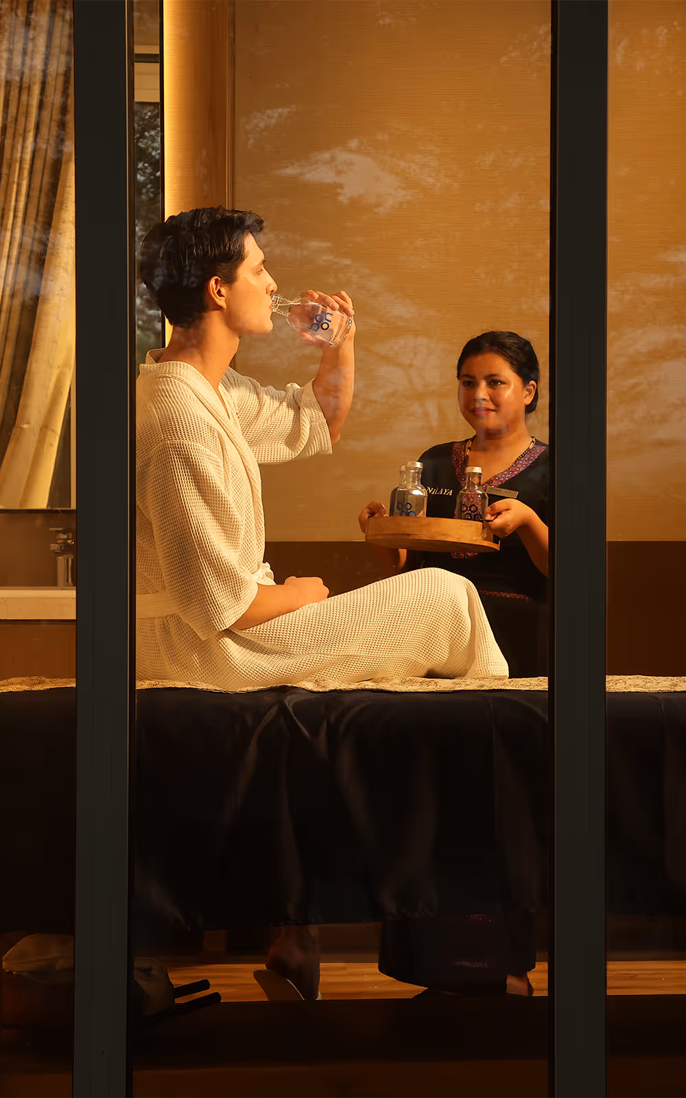 A guest in a hotel being served water
