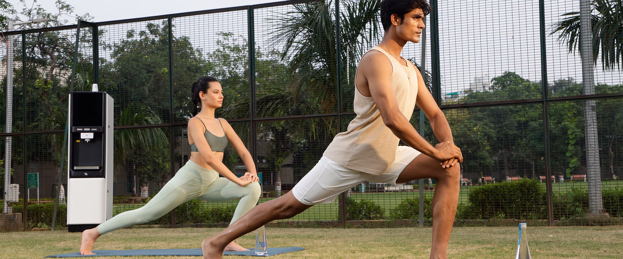 A couple excercising on a yoga mat