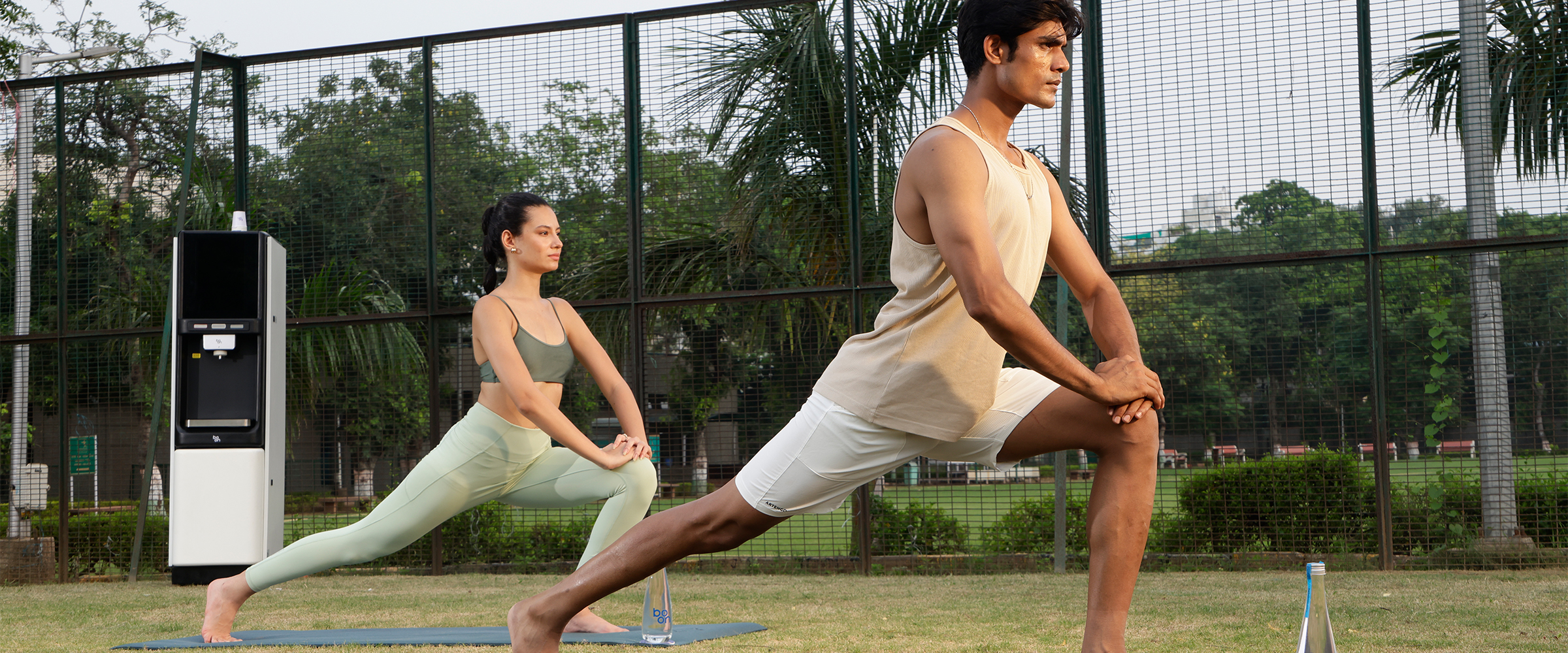 A couple excercising on a yoga mat