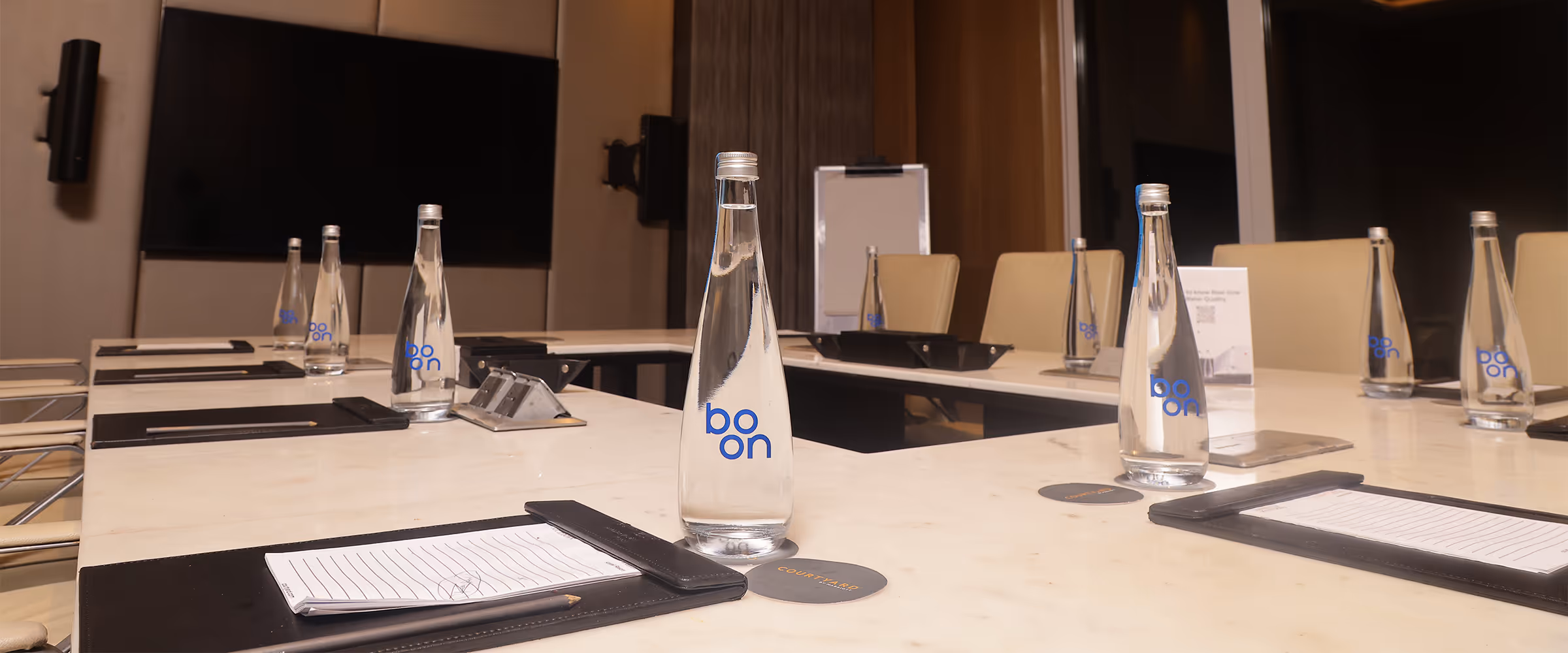 Boon water bottles on a hotel conference room