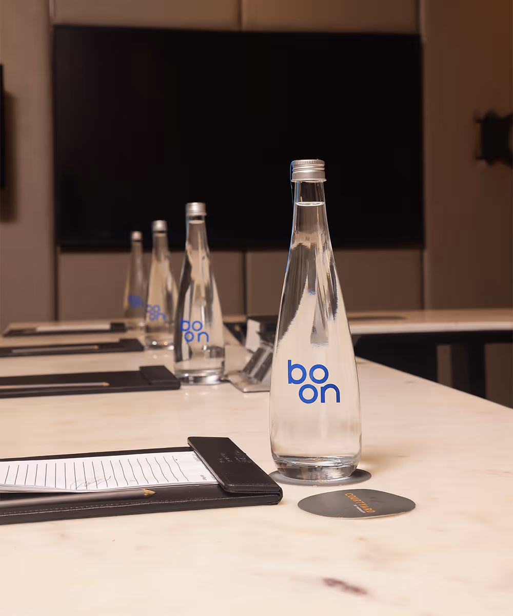 Boon water bottles on a hotel conference room