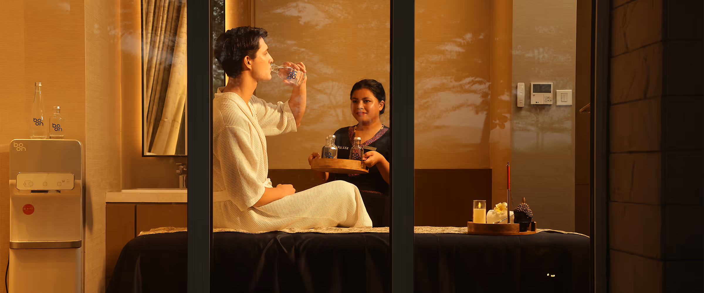 Guest in a hotel room drinking boon water