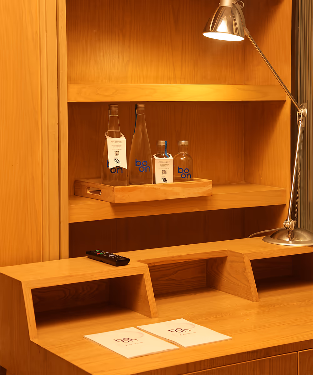 Boon water bottles in a hotel room drawer