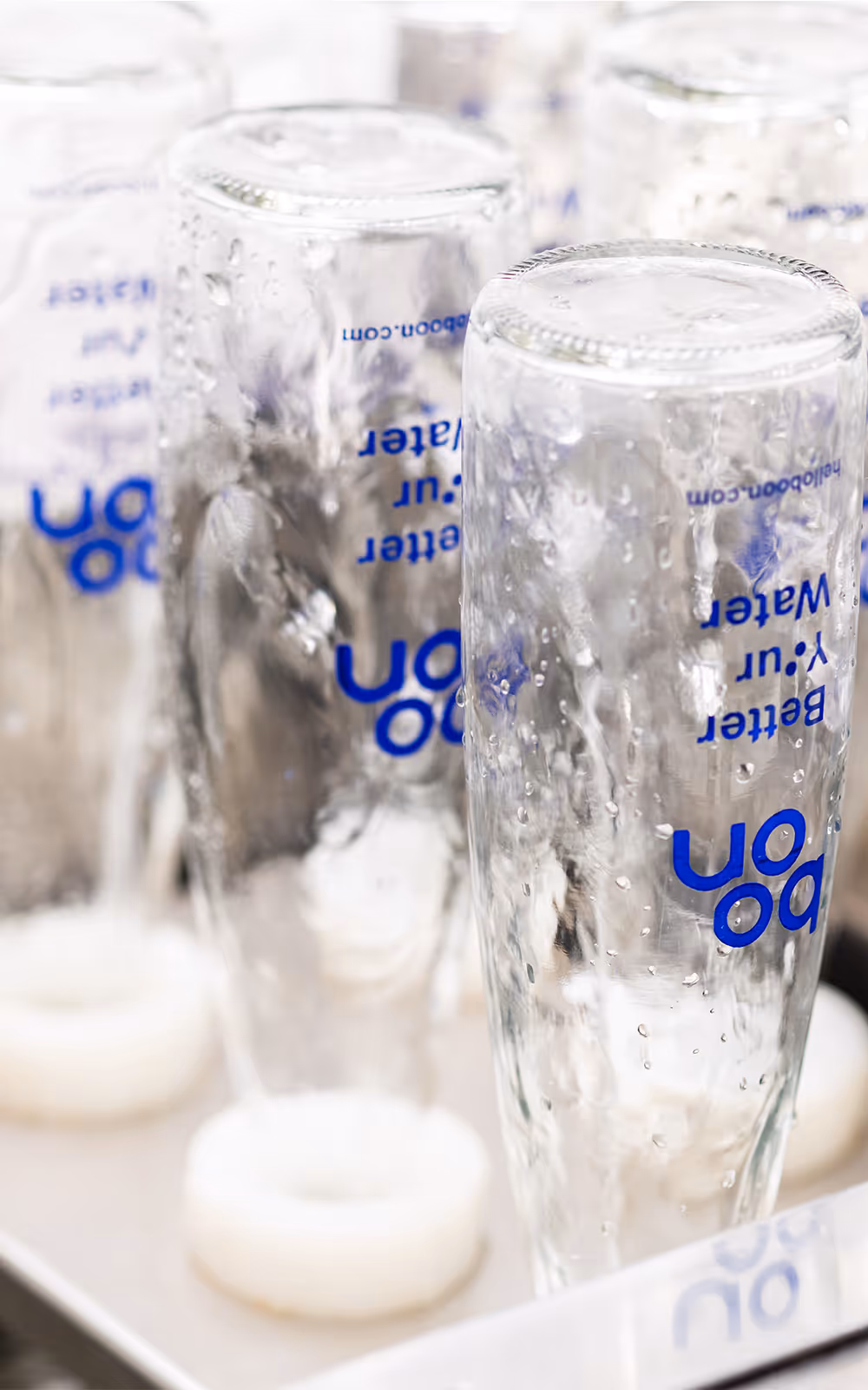 Boon water bottles in a washing chamber