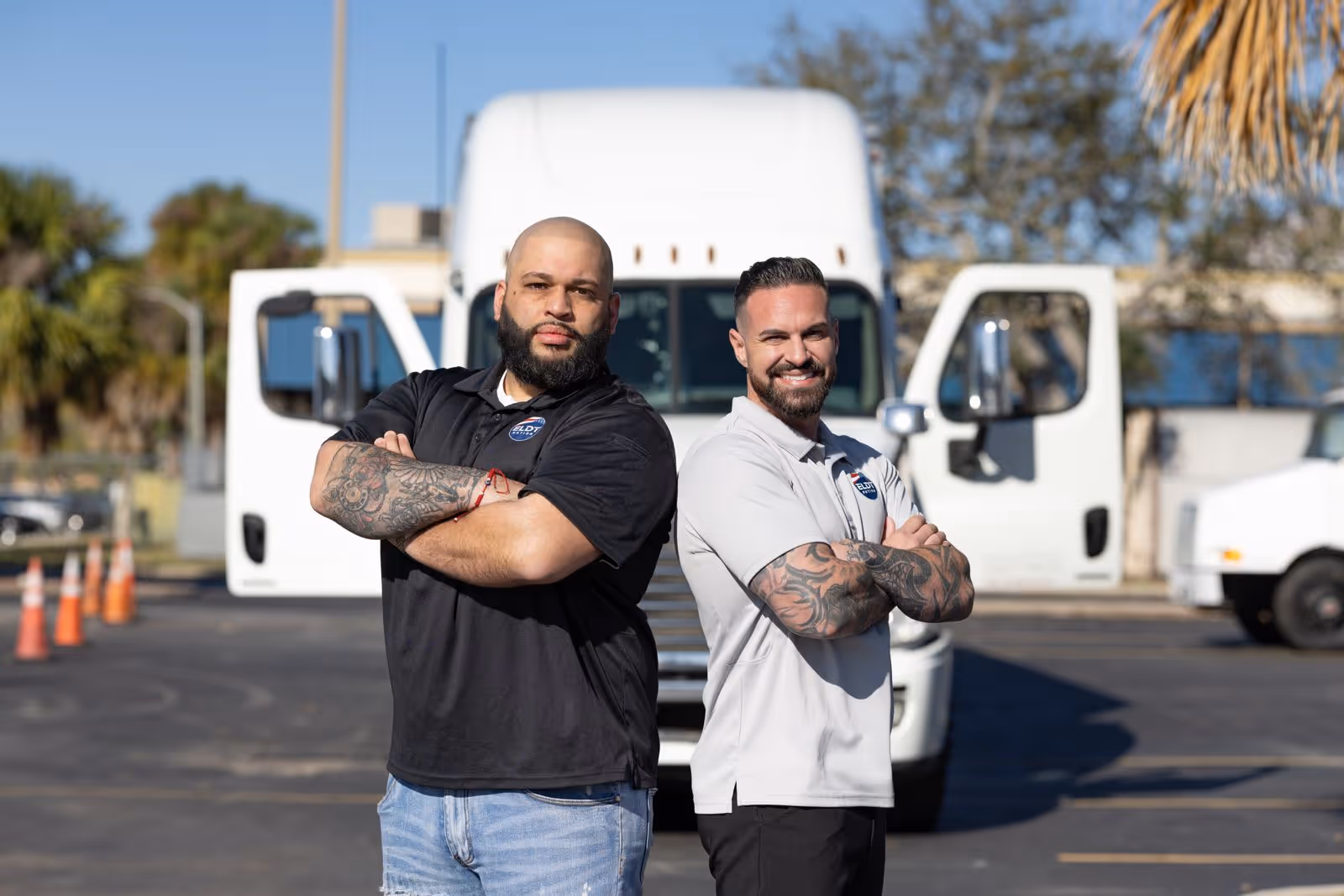 Two truck drivers standing side by side