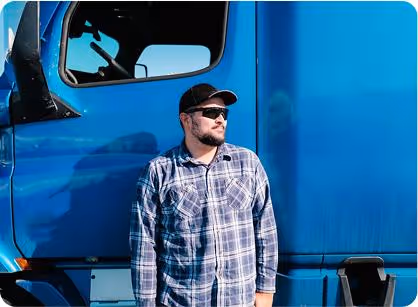Man standing next to blue truck