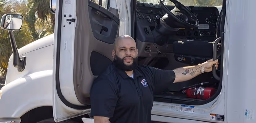 Man standing next to truck with door open