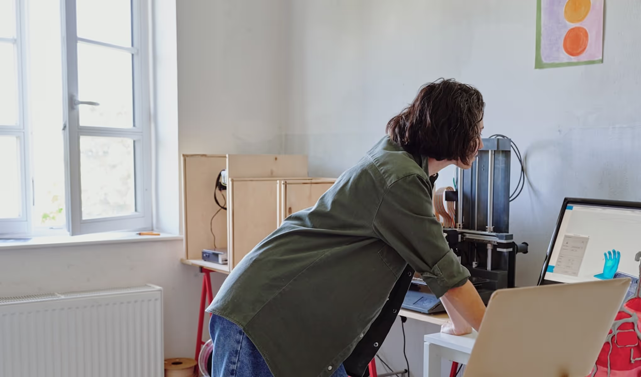 A woman working on a computer in a room.