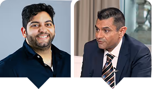 Two men in suits and ties sitting next to each other.