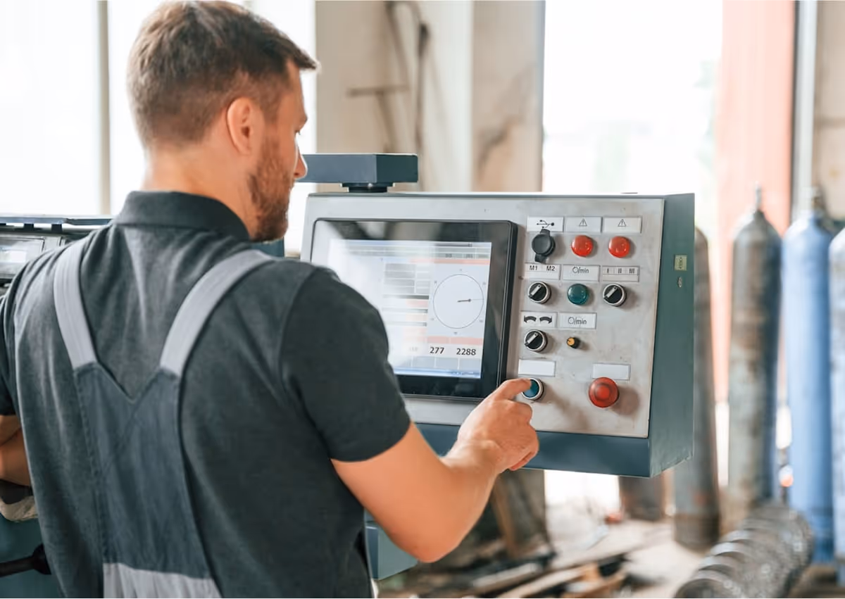 A man working on a machine in a factory.