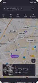 Mobile app screen showing a map with multiple price tags in AED currency and a bottom banner displaying a pro boxing package priced at 5985 AED.