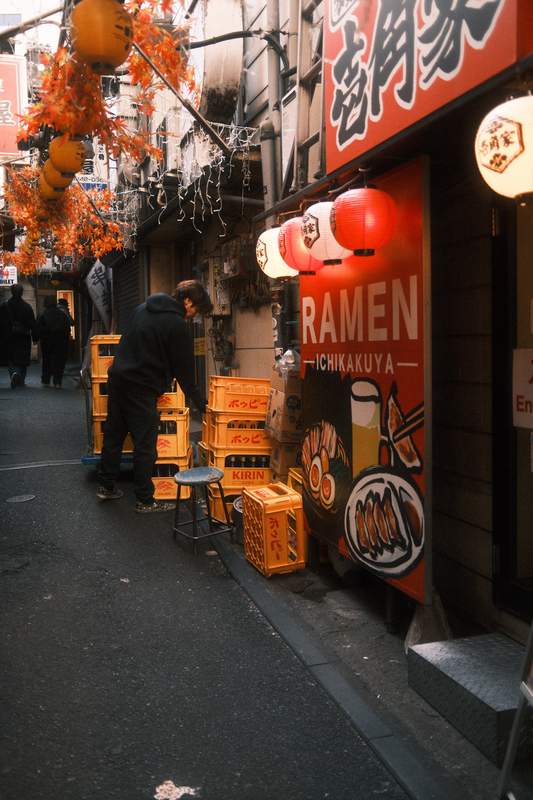 a tiny alley in tokyo full of colorful details