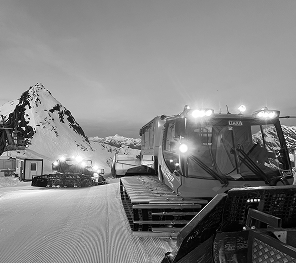 A snowcat on the top of the mountains transporting filming gear 