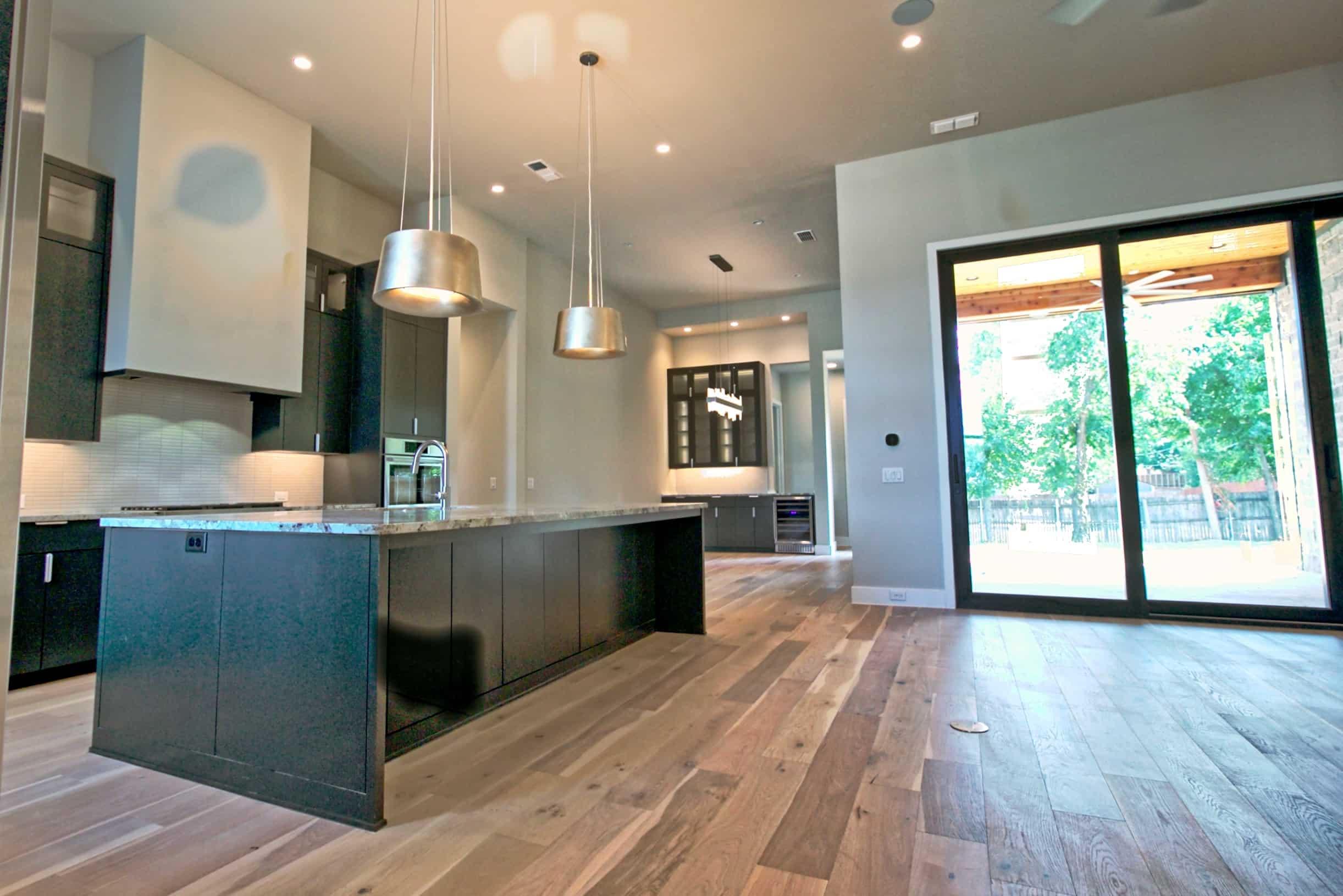 Luxury custom home interior featuring modern kitchen design — built by Oakmark Signature Homes, expert Texas home builders.