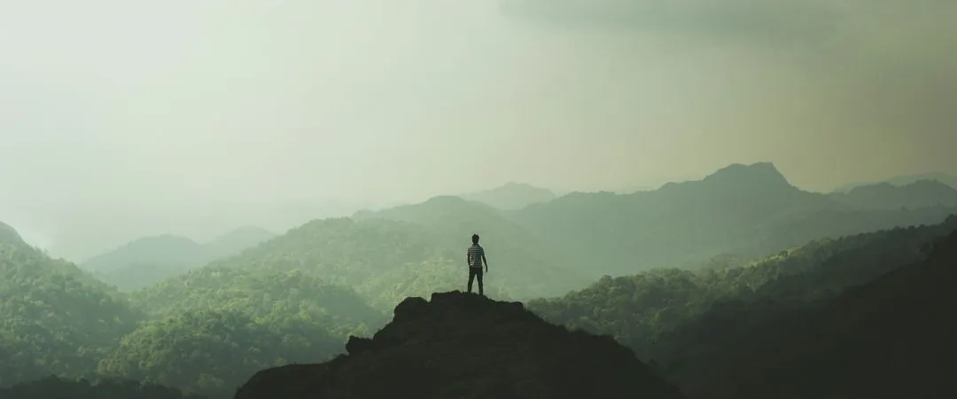 A person standing on top of a mountain.
