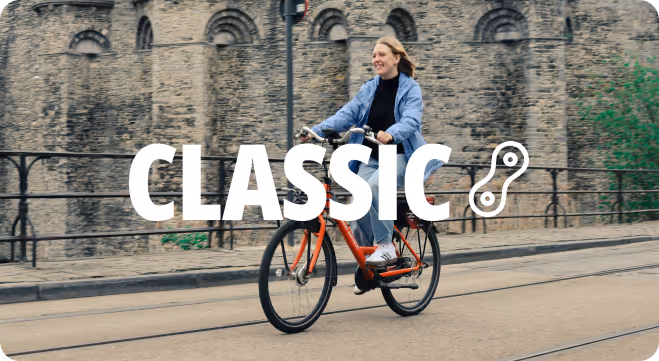 A woman riding a bike down a street.