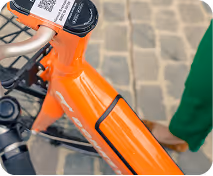 A close up of a person walking a bike.