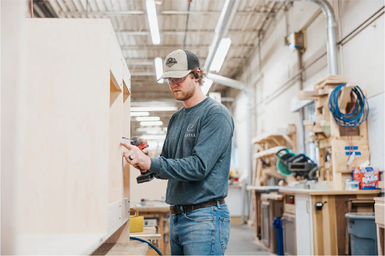 clazak worker drilling wood