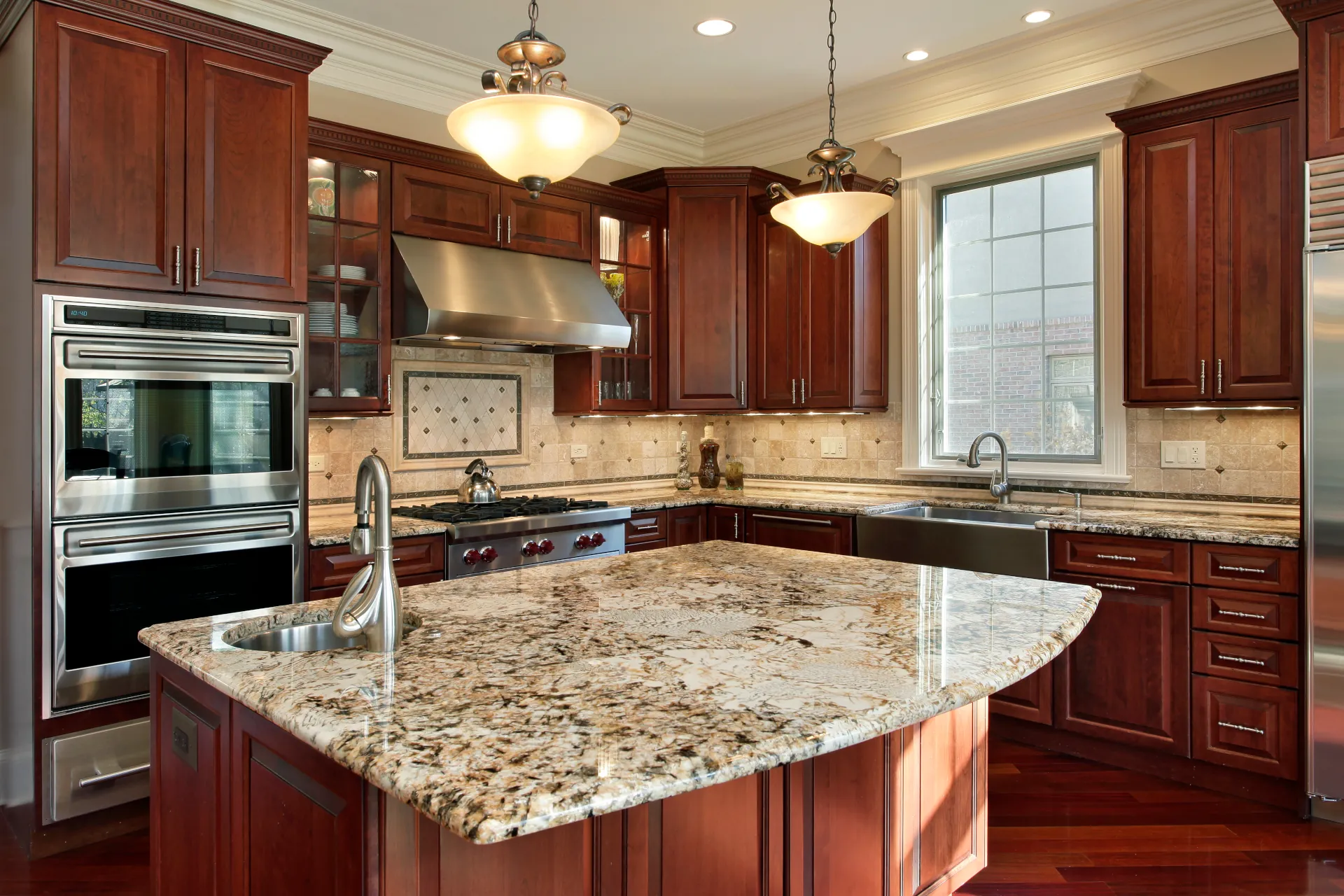 kitchen with brown cabinetry and granite countertops