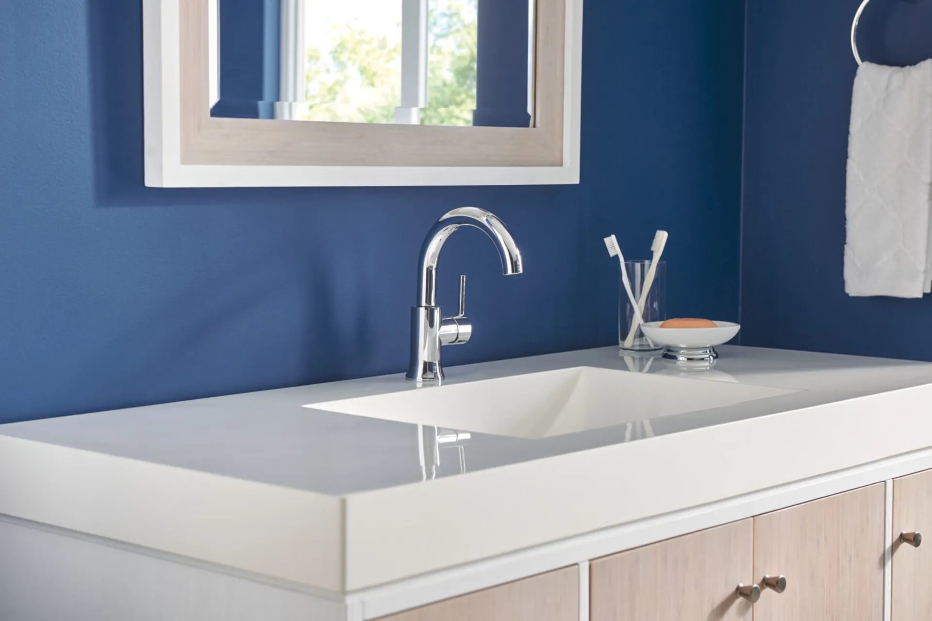 chrome faucet in a white and blue bathroom