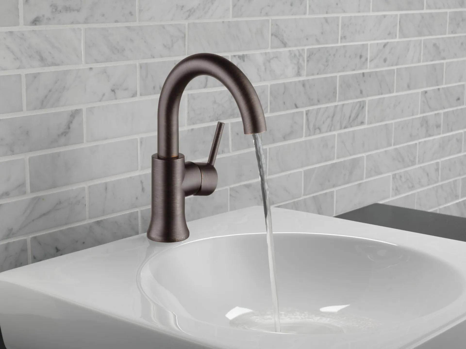 Venetian Bronze faucet in a white bathroom
