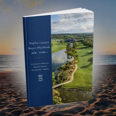 Small dining table with two stools and a window showing trees outside in a modern kitchen.